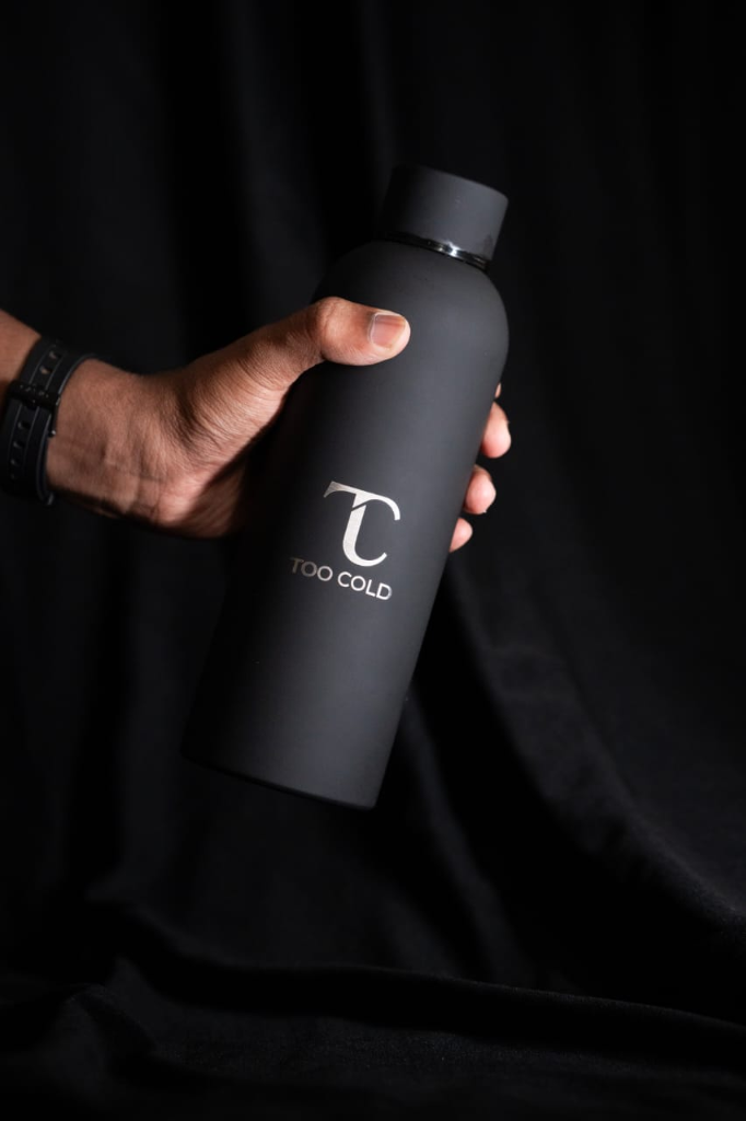 Customer holding TOO COLD bottle